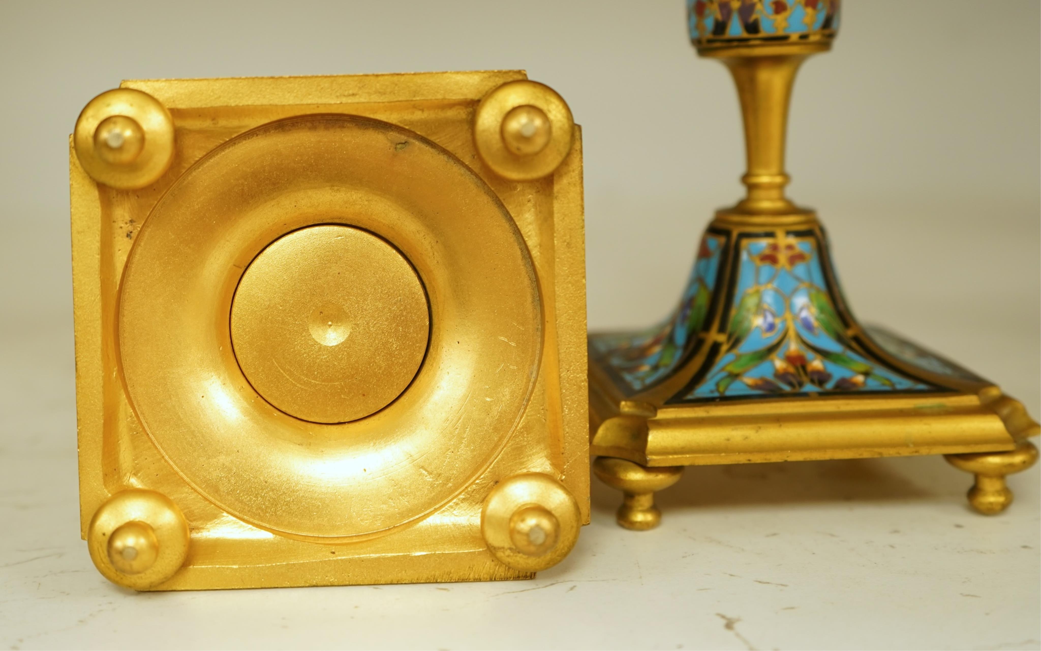 A pair of late 19th century French champleve enamel and ormolu candlesticks, 17cm